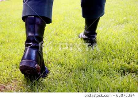 Body part a man walking.He walking on grass background.He wear black shoes.going,move on,fright,develop,Grow up. Body part a man walking.He walking on grass background.He wear black shoes.going,move on,fright,develop,Grow up. 63073384