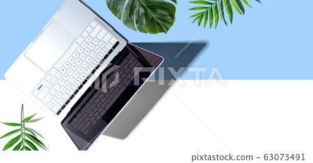 Laptop computer with tropical plants Laptop computer with tropical plants 63073491