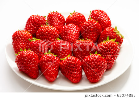 Strawberries served on a white round plate. (White background) Strawberries served on a white round plate. (White background) 63074883