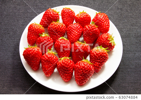 Strawberries served on a white round plate. Strawberries served on a white round plate. 63074884