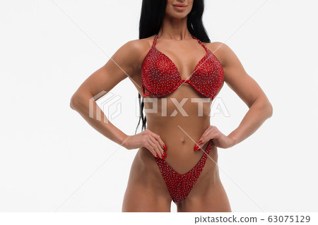 Sportswoman in red bikini in studio Sportswoman in red bikini in studio 63075129