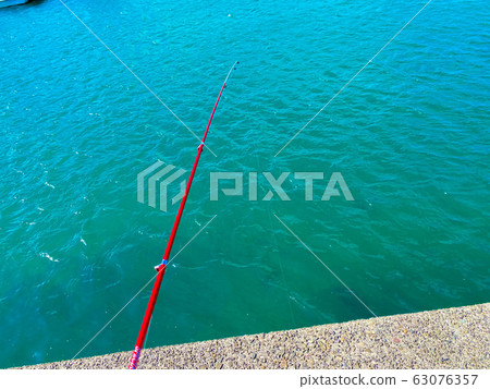 在防波堤上釣魚。 63076357