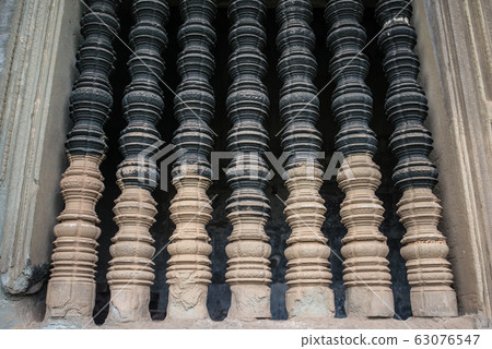 The old window made by stone in ancient Khmer temple in Siem Reap, Cambodia. The old window made by stone in ancient Khmer temple in Siem Reap, Cambodia. 63076547