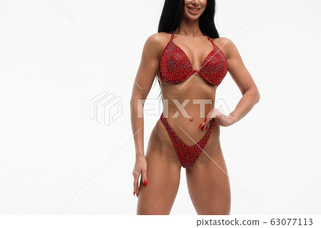 Sportswoman in red bikini in studio 63077113