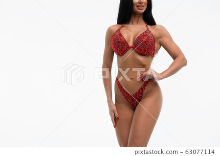 Sportswoman in red bikini in studio Sportswoman in red bikini in studio 63077114