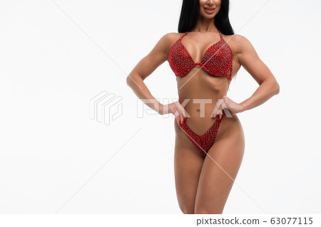 Sportswoman in red bikini in studio Sportswoman in red bikini in studio 63077115