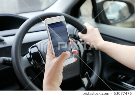 Driving while smartphone Driving while smartphone 63077476