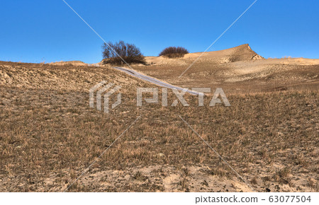 View of nordic sand dunes and pathways, Baltic sea at Curonian spit, Nida, Klaipeda, Lithuania 63077504