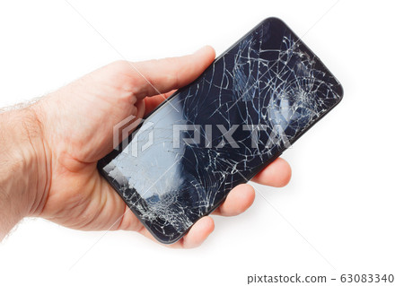 Hand holds a broken smartphone on a white 63083340
