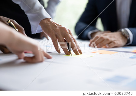 Close up of diverse businesspeople collaborating at meeting Close up of diverse businesspeople collaborating at meeting 63083743