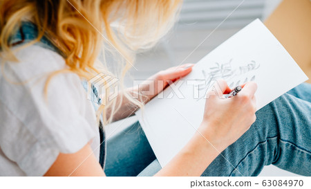 art therapy woman drawing plants sitting floor 63084970