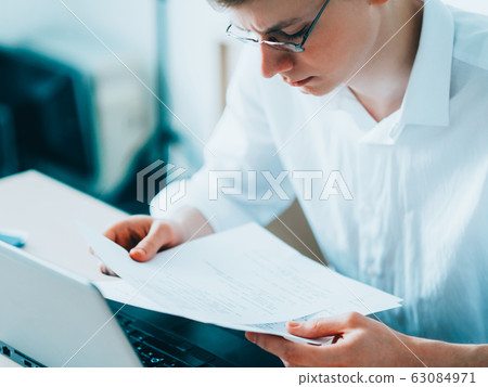 corporate life male manager reading documents 63084971