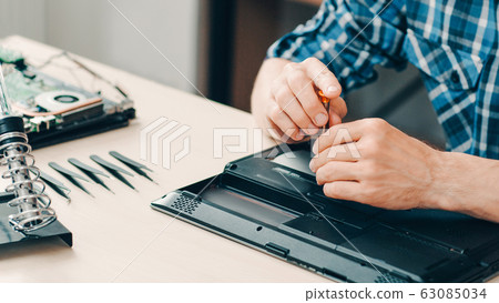 repair shop engineer working disassembled laptop repair shop engineer working disassembled laptop 63085034