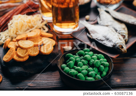 Two mugs of lager and selection of beer snacks Two mugs of lager and selection of beer snacks 63087136