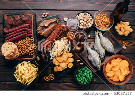 Two mugs of lager and selection of beer snacks Two mugs of lager and selection of beer snacks 63087137