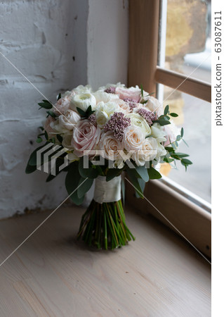 beautiful wedding bouquet flowers windowsill 63087611