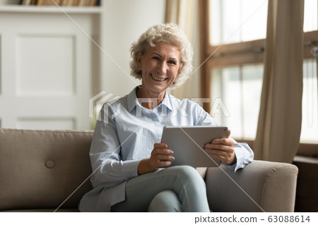 Portrait of smiling mature woman using modern tablet 63088614
