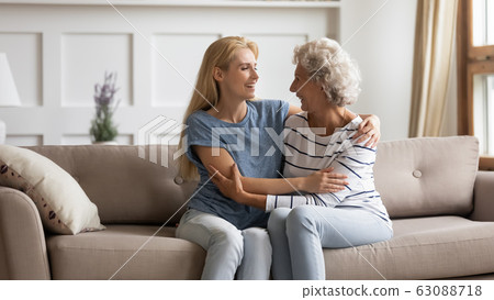 Happy mature mom and adult daughter relax at home together 63088718