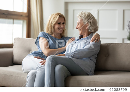 Overjoyed adult mom and daughter have fun at home 63088799