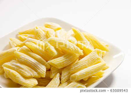 Raw pasta penne. (White plate, white background) 63089543