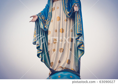 The blessed Virgin Mary statue figure in a sunset 63090027
