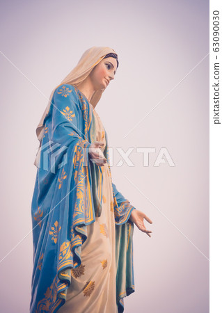 The blessed Virgin Mary statue figure in a sunset The blessed Virgin Mary statue figure in a sunset 63090030