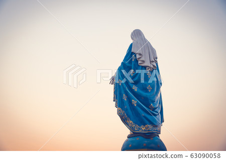 The blessed Virgin Mary statue figure in a sunset 63090058