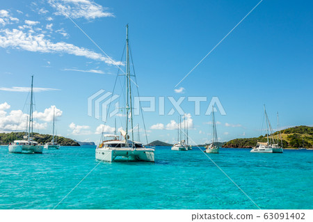 Turquoise colored sea with ancored yachts and Turquoise colored sea with ancored yachts and 63091402
