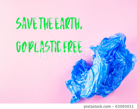 Crumpled blue plastic trash bag on pink background Crumpled blue plastic trash bag on pink background 63093031
