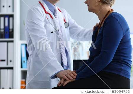 Physician supporting ill patient 63094795