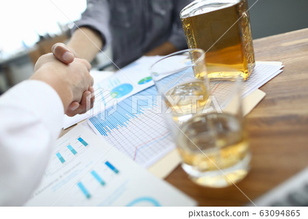 Glasses with whiskey on table Glasses with whiskey on table 63094865