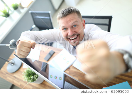 Cheerful man at workplace Cheerful man at workplace 63095003