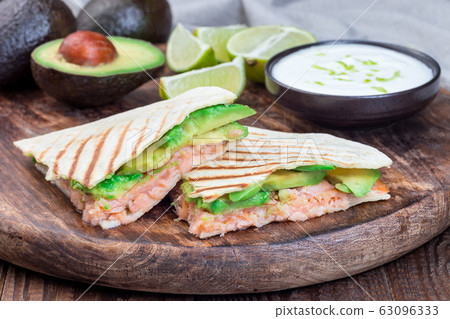 Grilled quesadilla with smoked salmon and avocado Grilled quesadilla with smoked salmon and avocado 63096333