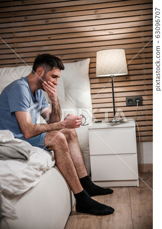 Young man with tracker in bedroom stock photo 63096707
