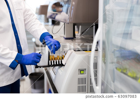 Male researcher is using research machine in laboratory Male researcher is using research machine in laboratory 63097083