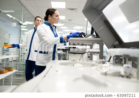 Research scientists working in laboratory with modern equipment Research scientists working in laboratory with modern equipment 63097211