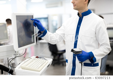 Young researcher using modern equipment in science lab Young researcher using modern equipment in science lab 63097213