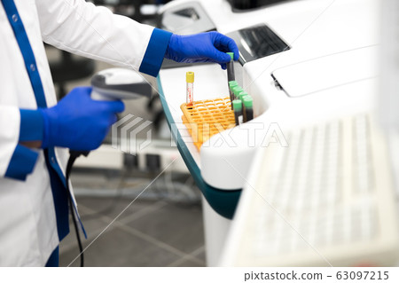 Laboratory technician doing pathology blood test in lab Laboratory technician doing pathology blood test in lab 63097215