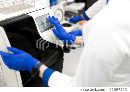 Scientist using advia immunoassay system in laboratory Scientist using advia immunoassay system in laboratory 63097223