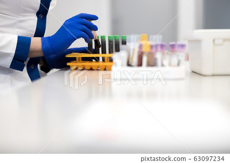Female scientist taking blood test tube for laboratory research Female scientist taking blood test tube for laboratory research 63097234