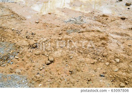 Texture of a dirty bad dirt road dirt road with  63097806