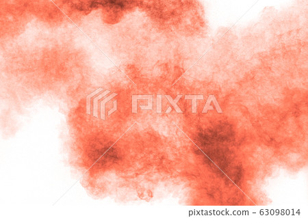 Abstract explosion of orange dust on white 63098014