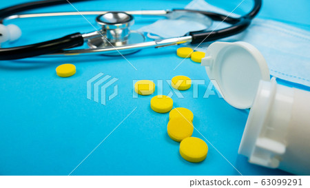 Stethoscope and Face Mask on Blue Background 63099291