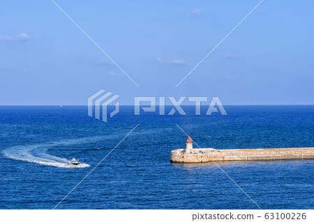 Sea Motorboat And Ricasoli Lighthouse Breakwater 63100226