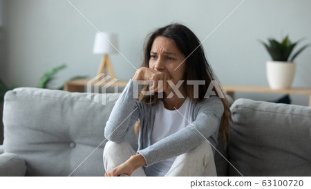 Upset young woman look in distance thinking 63100720