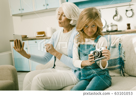 Grandma And Her Grandchild Learn Unusual Gadgets 63101053