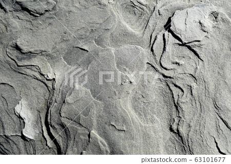 Background texture of stone with smooth streaks, natural surface of sandy soil. Black, white and gray tones. Background texture of stone with smooth streaks, natural surface of sandy soil. Black, white and gray tones. 63101677
