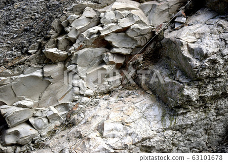 Texture of sand and clay rocks. The view is in black, gray and white. Texture of sand and clay rocks. The view is in black, gray and white. 63101678
