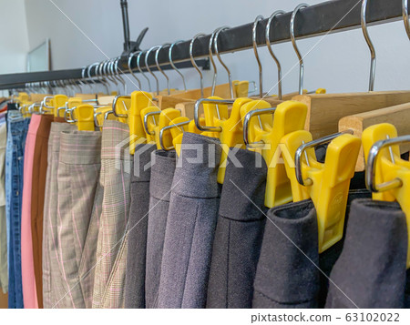 Pants hanging on shelf at retail clothing store Pants hanging on shelf at retail clothing store 63102022