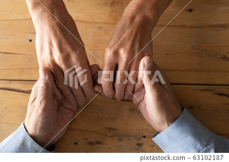 Top view of loving elderly couple hold hands Top view of loving elderly couple hold hands 63102187